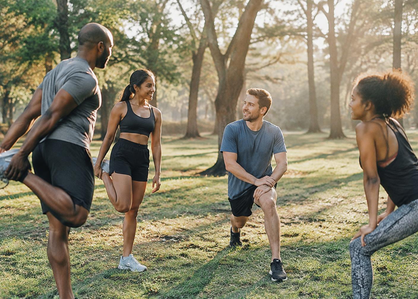 Athletes stretching together in a park